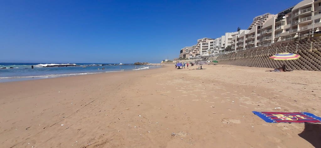 Umdloti Beach looking north along the sand towards the beachfront apartment blocks